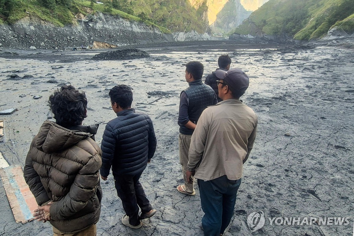 홍수가 발생한 부디 간다키강 진흙 위에 서 있는 현지민들